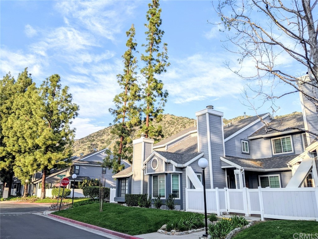 1641 Dimas Court Azusa, CA 91702 - Photo 6 of 14 a front view of a residential houses with yard and green space