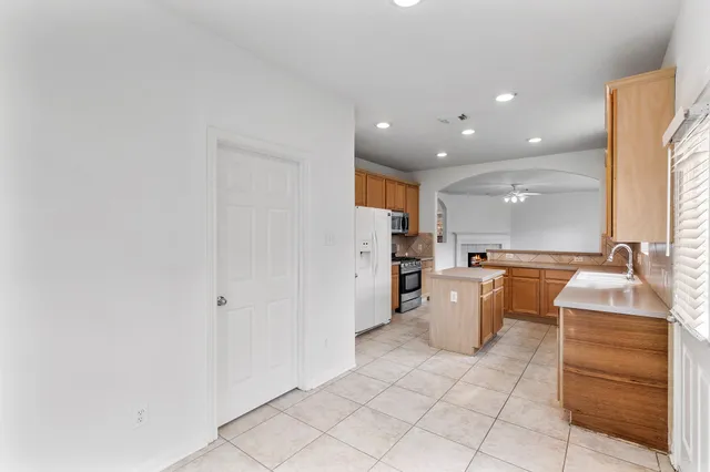 a kitchen with a sink and refrigerator
