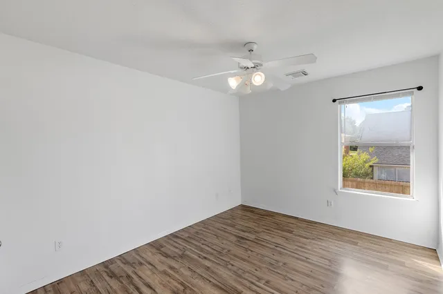wooden floor in an empty room with a window