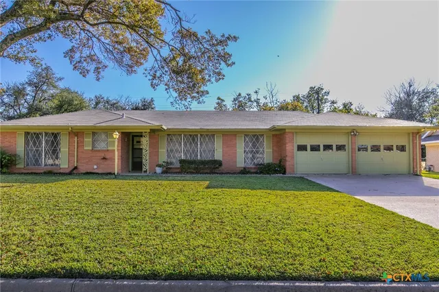 a view of an house with backyard space and balcony