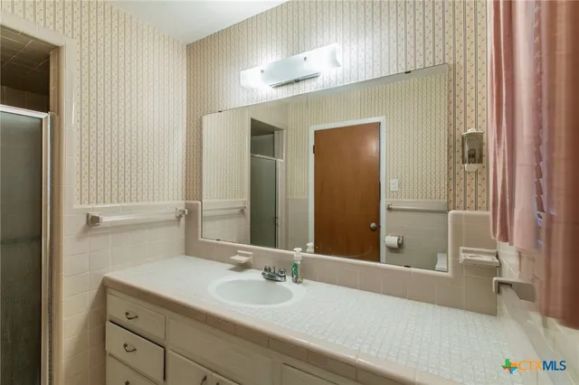 a bathroom with a sink a mirror and a bathtub