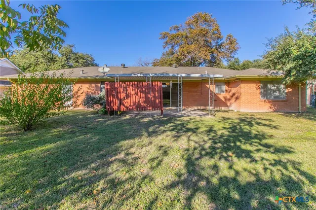 a view of a yard with a tree in a yard