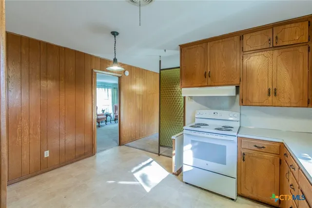 a kitchen with a stove and a refrigerator