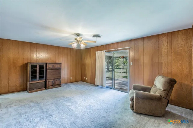 a view of livingroom with furniture and chandelier fan