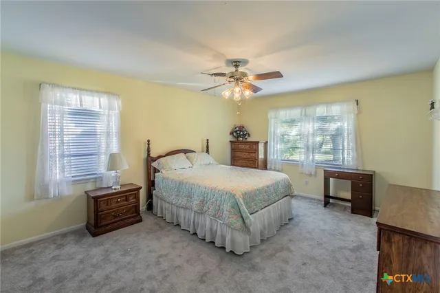 a spacious bedroom with a bed and a table in it