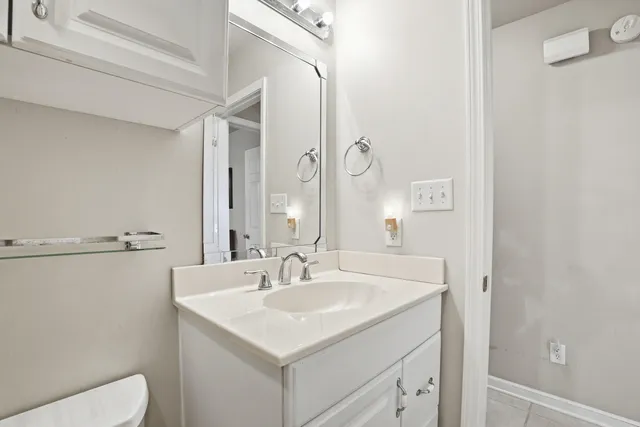a kitchen with white cabinets and appliances