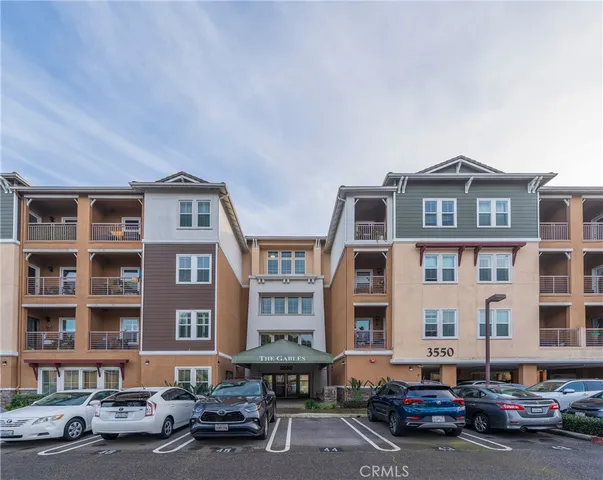 a couple of cars parked in front of a building