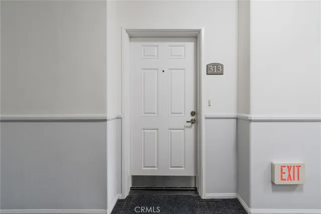 a living room with furniture a large window and a projector