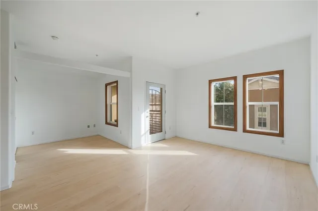 an empty room with windows and closet