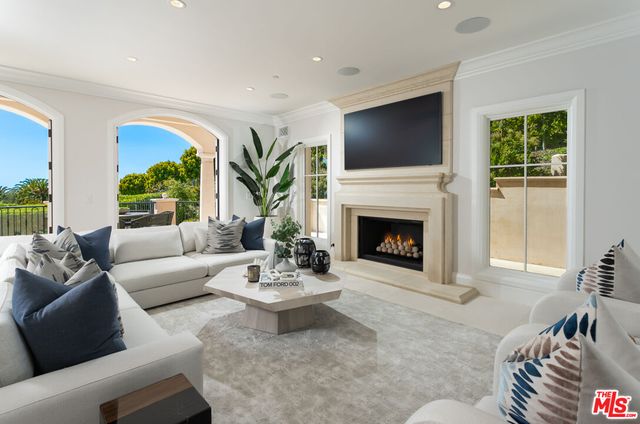 a view of a balcony with furniture and a floor to ceiling window