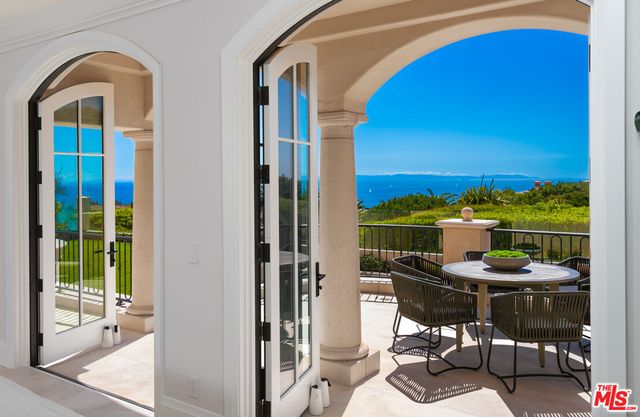 a view of a roof deck with couches and sky view