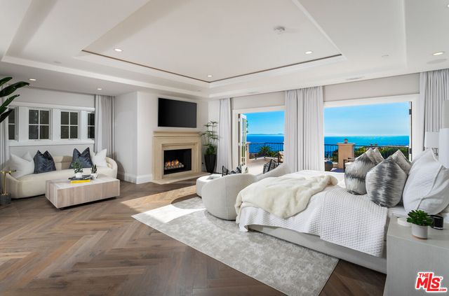 a living room with couches a coffee table and a flat screen tv