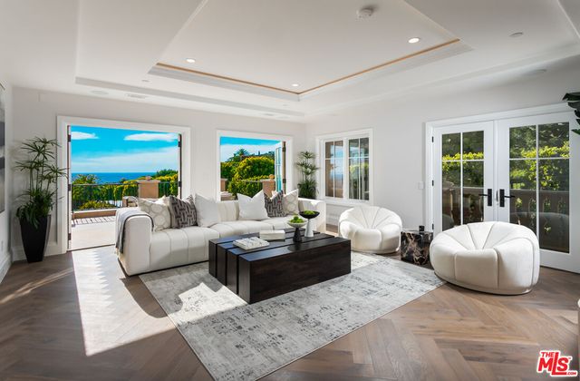 an outdoor sitting area with furniture and city view