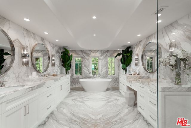a view of a hallway with entryway and chandelier