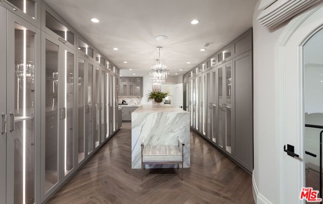 a spacious bedroom with a bed and wooden floor