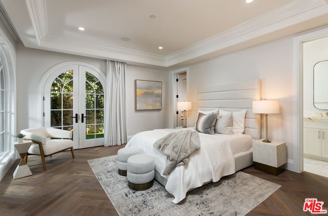 a bedroom with a bed and a flat screen tv