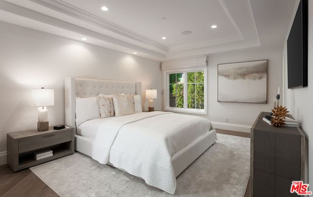 a large white kitchen with stainless steel appliances kitchen island granite countertop a large counter top stainless steel appliances and cabinets