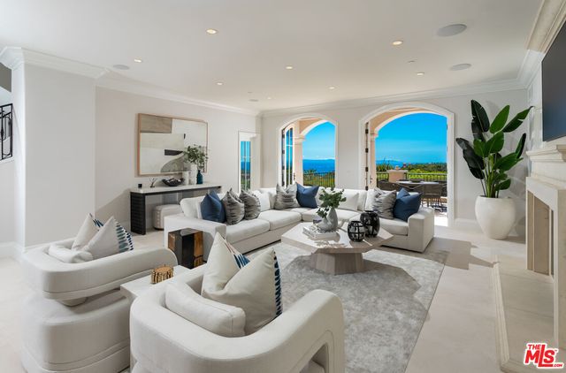 a living room with furniture fireplace and kitchen view