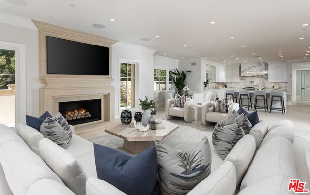 a living room with furniture fireplace and a flat screen tv