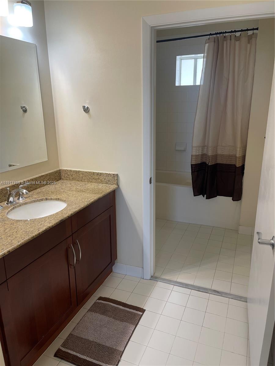7280 Southwest 90th Street, Unit 708 Miami, FL 33156 - Photo 11 of 18 a bathroom with a sink a vanity and mirror