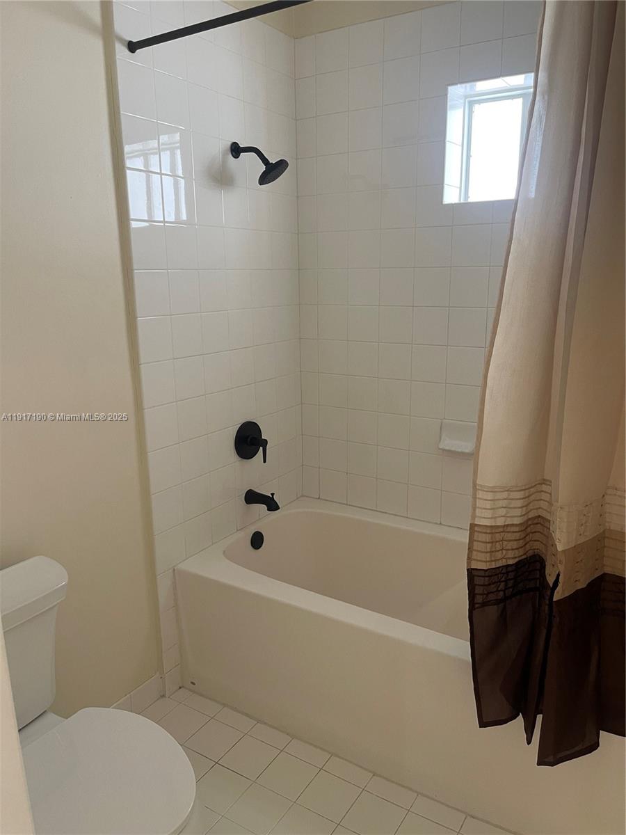 7280 Southwest 90th Street, Unit 708 Miami, FL 33156 - Photo 13 of 18 a bathroom with a toilet and a shower