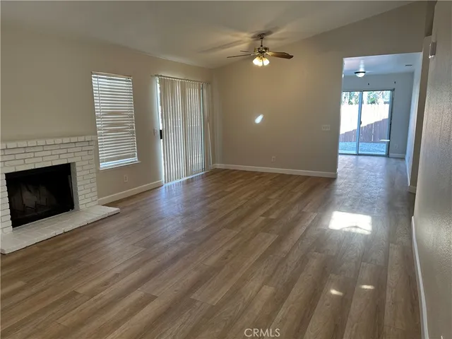 wooden floor in an empty room with a fireplace