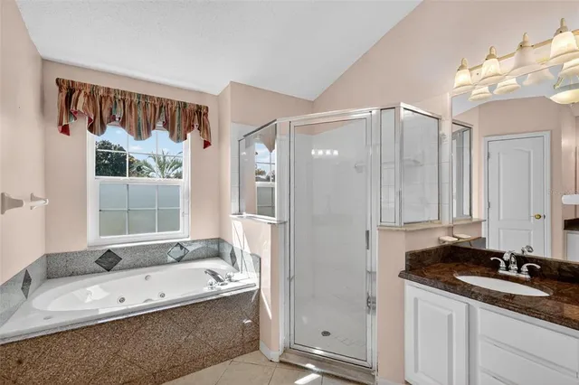 an empty room with windows and ceiling fan