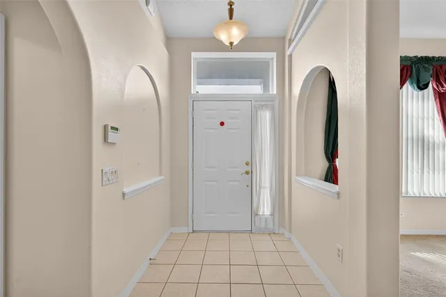 an entryway with a bed and a window