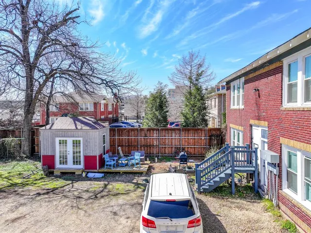 a view of a house with backyard and sitting area
