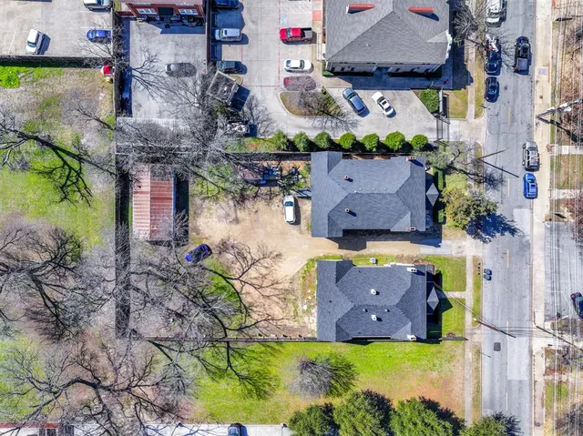 an aerial view of a house with yard