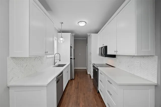 a kitchen with granite countertop a sink and cabinets