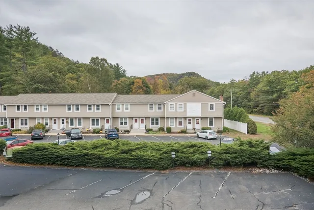 a view of cars parked in front of a house