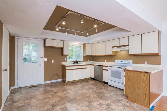 a kitchen with granite countertop a sink stainless steel appliances and cabinets