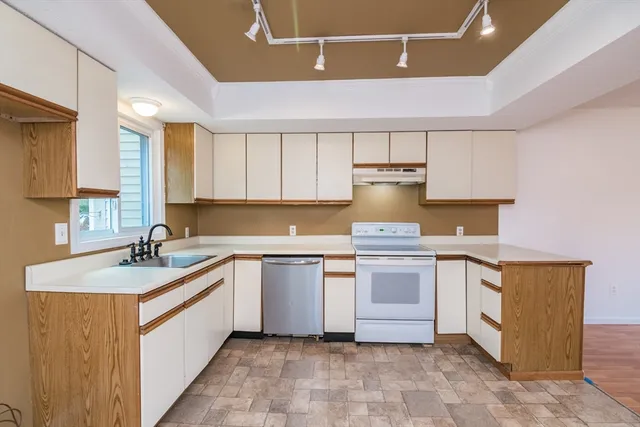 a kitchen with a sink stove and cabinets