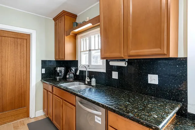 a kitchen with stainless steel appliances granite countertop a stove microwave and refrigerator