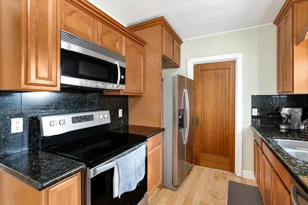 a kitchen with stainless steel appliances granite countertop a stove a sink and a granite counter tops