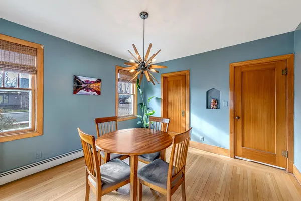 a view of a dining room with furniture window and wooden floor