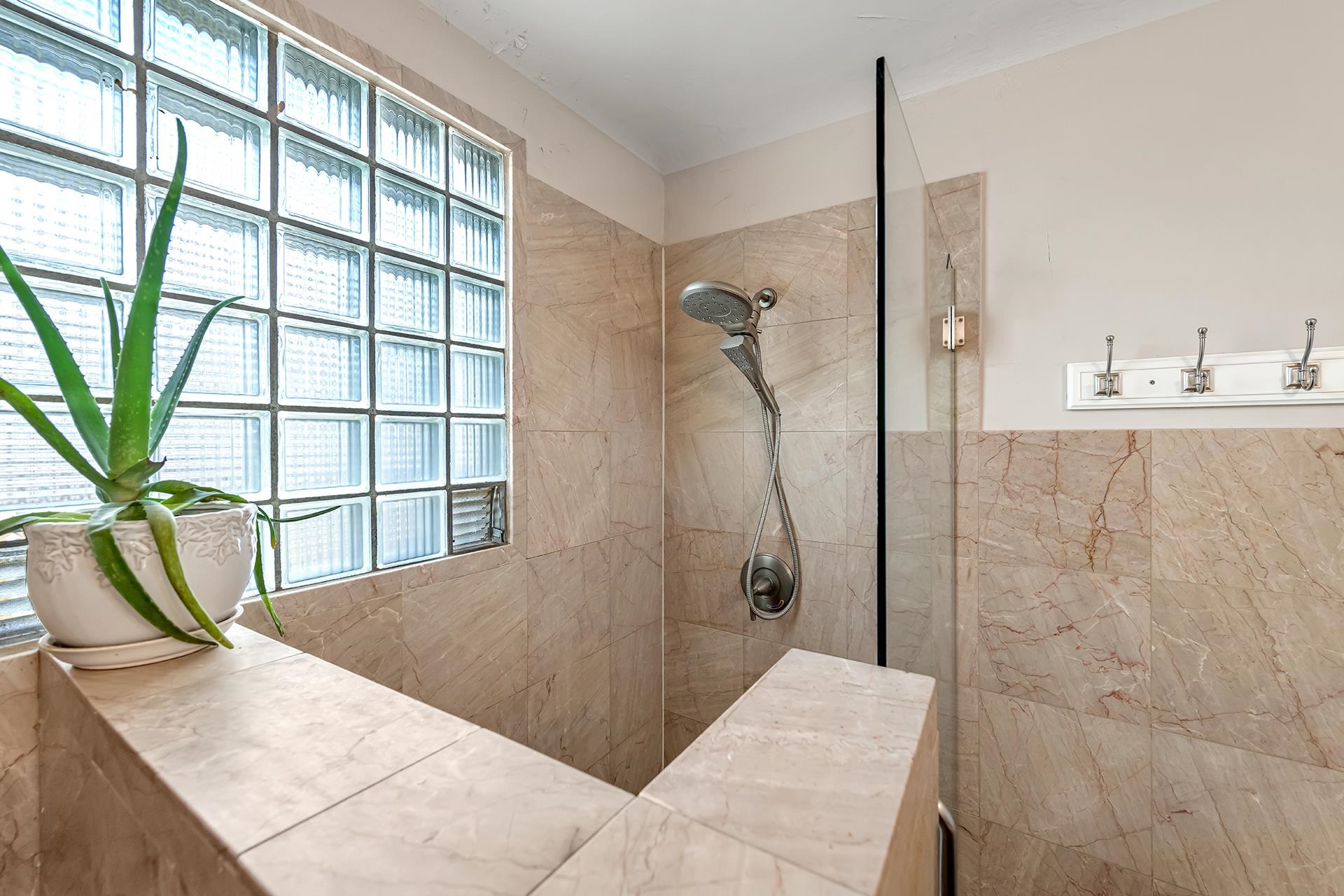 508 Main Street Palisade, CO 81526 - Photo 30 of 40 a bathroom with a granite countertop sink a mirror and shower