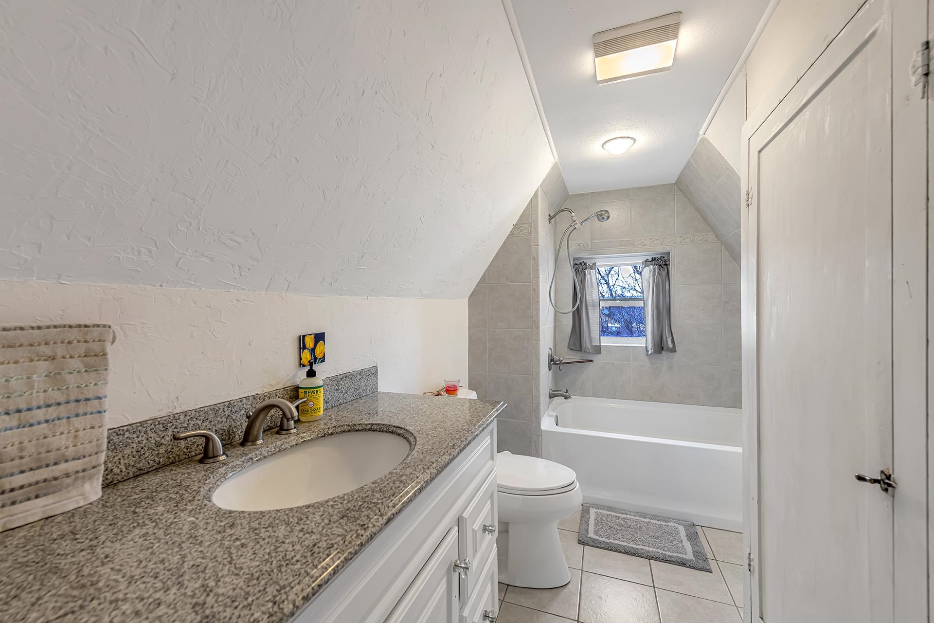 508 Main Street Palisade, CO 81526 - Photo 35 of 40 a bathroom with a granite countertop sink mirror vanity and toilet