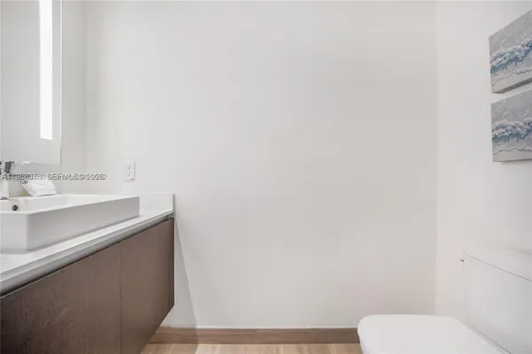 a bathroom with a sink a toilet and mirror