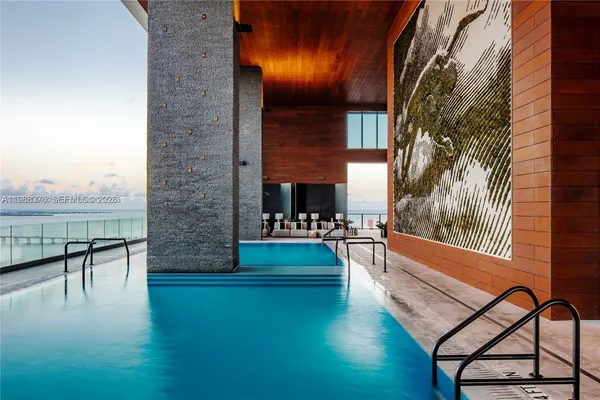 swimming pool view with a seating space