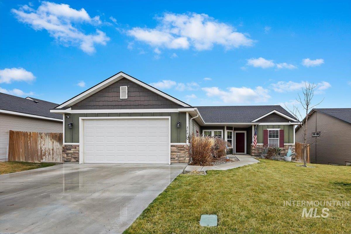 389 Arrow Street Twin Falls, ID 83301 - Photo 1 of 34 View of front of home with stone siding, concrete driveway, a garage, and board and batten siding