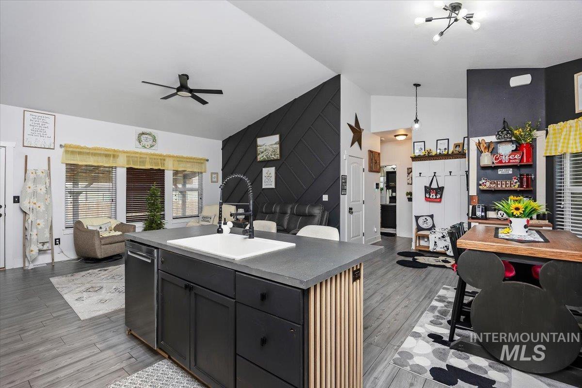 389 Arrow Street Twin Falls, ID 83301 - Photo 34 of 34 Kitchen with lofted ceiling, a center island with sink, open floor plan, ceiling fan, and wood finished floors