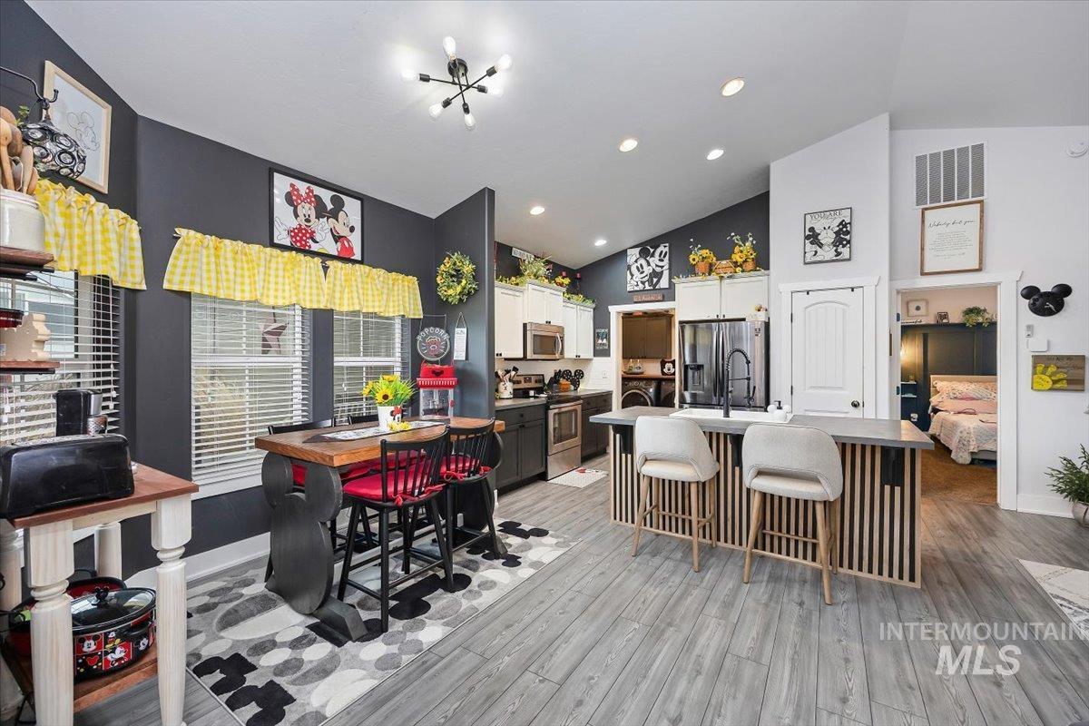 389 Arrow Street Twin Falls, ID 83301 - Photo 13 of 34 Dining room with lofted ceiling, recessed lighting, and light wood finished floors