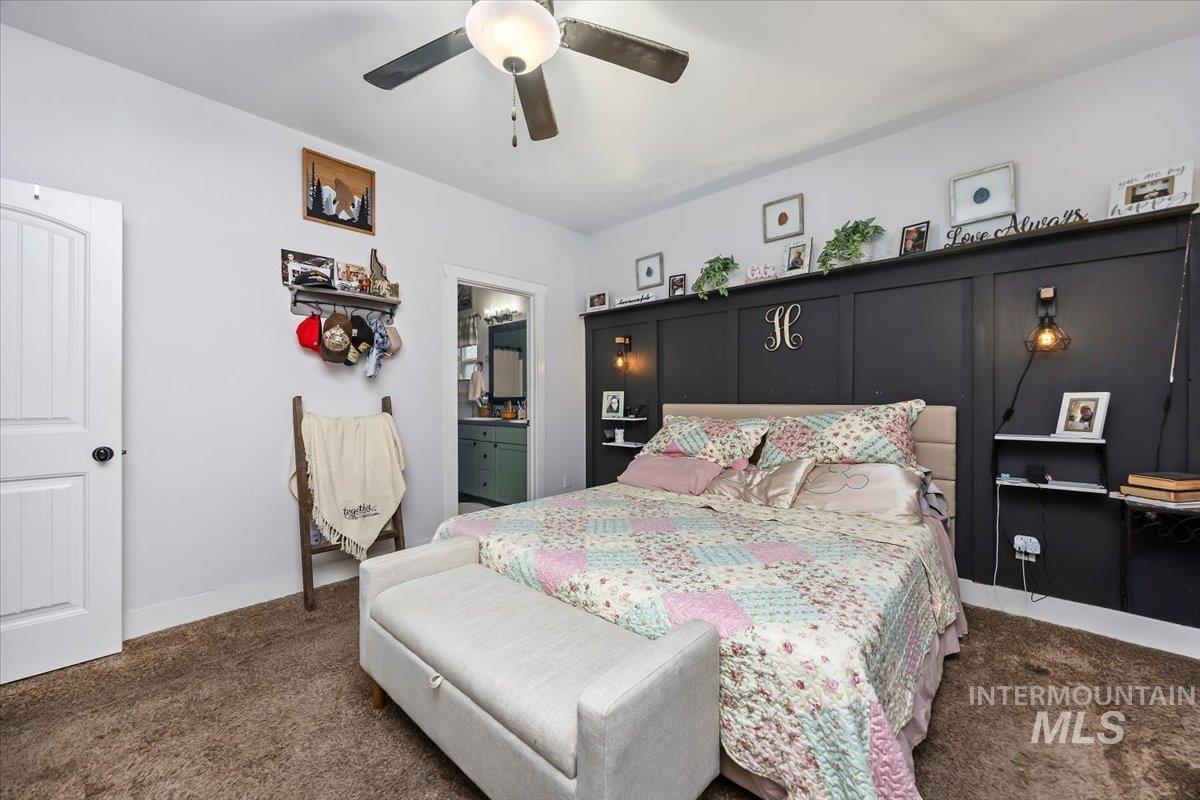 389 Arrow Street Twin Falls, ID 83301 - Photo 16 of 34 Bedroom featuring dark colored carpet, a ceiling fan, and ensuite bath