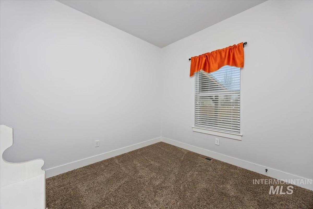 389 Arrow Street Twin Falls, ID 83301 - Photo 20 of 34 Spare room with dark carpet and lofted ceiling