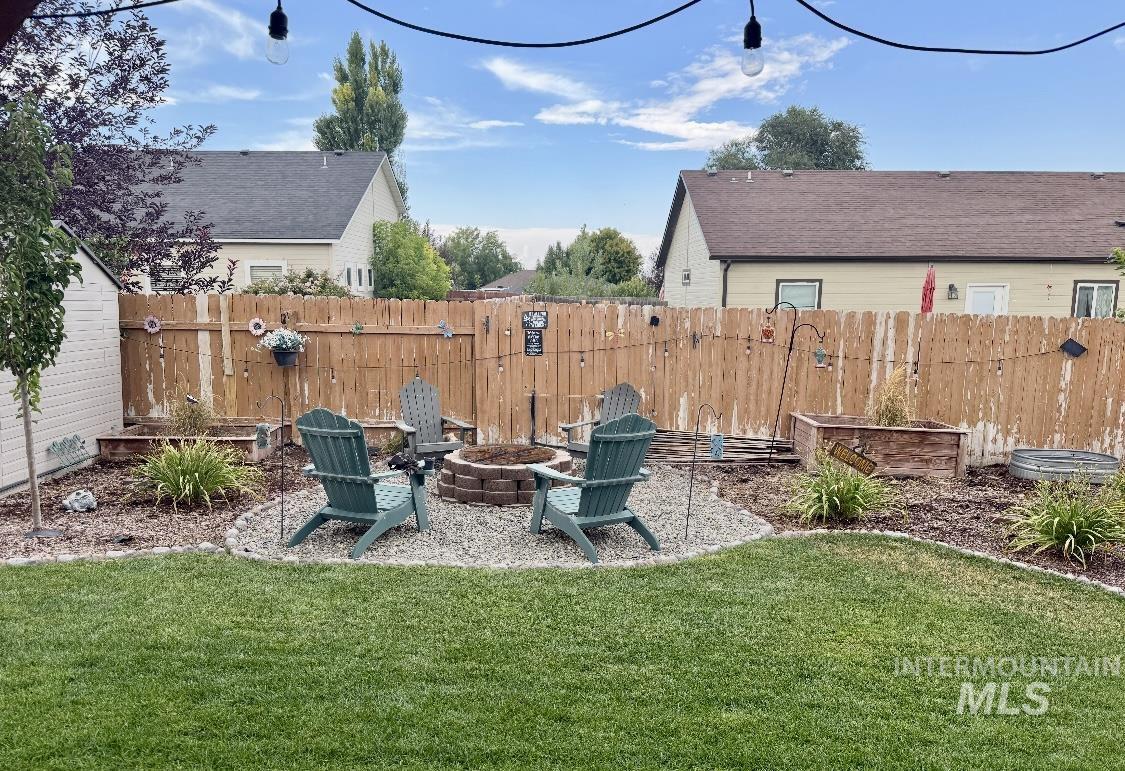 389 Arrow Street Twin Falls, ID 83301 - Photo 29 of 34 Fenced backyard with a patio and an outdoor fire pit
