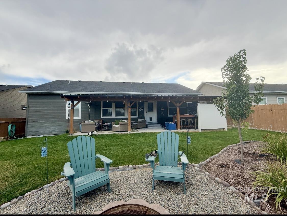 389 Arrow Street Twin Falls, ID 83301 - Photo 32 of 34 Back of house with a patio and an outdoor living space with a fire pit