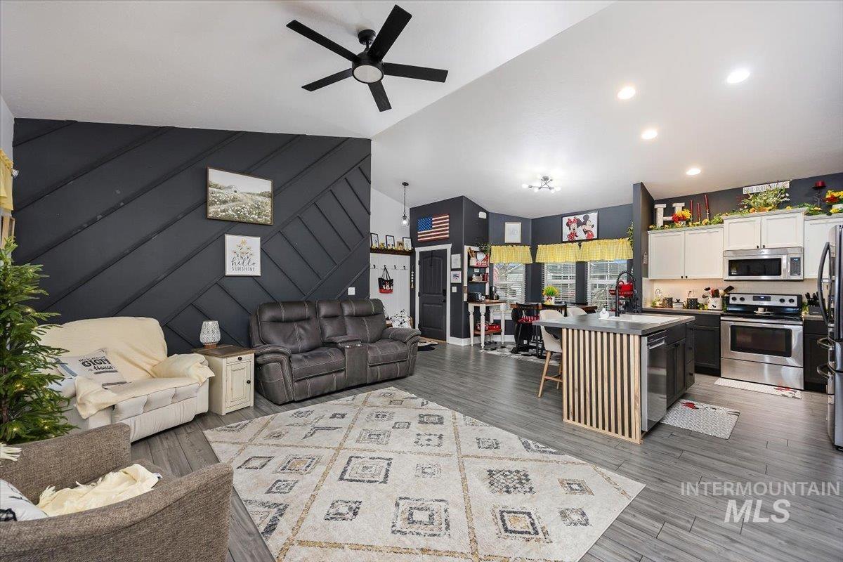 389 Arrow Street Twin Falls, ID 83301 - Photo 6 of 34 Living room with an accent wall, a ceiling fan, light wood-style flooring, recessed lighting, and vaulted ceiling