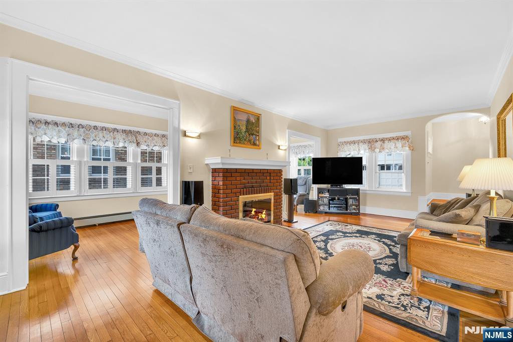 106 Maple Street Rutherford, NJ 07070 - Photo 7 of 50 a living room with furniture a flat screen tv and a fireplace